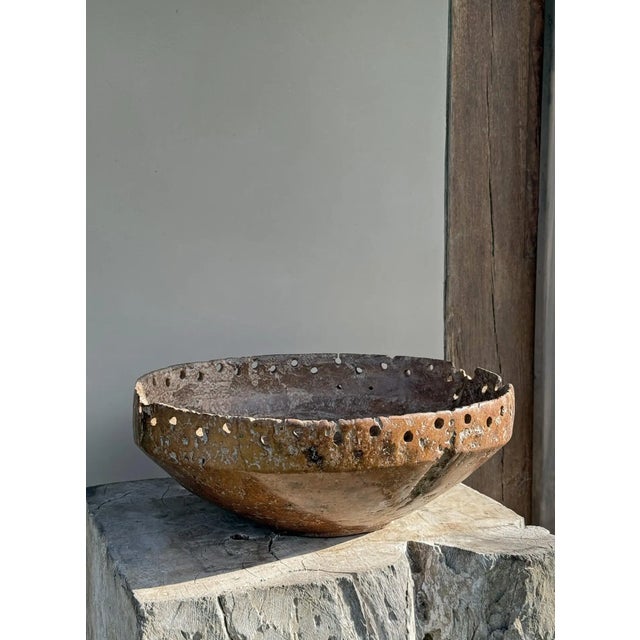 This striking bowl, carved from richly grained burl teak wood, dates back to the early 20th century and carries a unique...