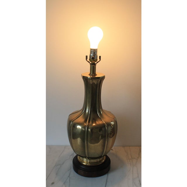 Vintage brass table lamp w/ wood base. I believe this lamp is made by Frederick Cooper but it is unmarked. Some light age...