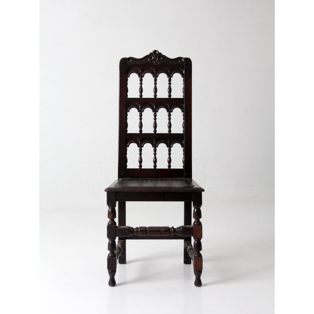 Antique Victorian Spindle-Back Chair with Carved Crest and Leather Seat. This striking chair features a tall,...