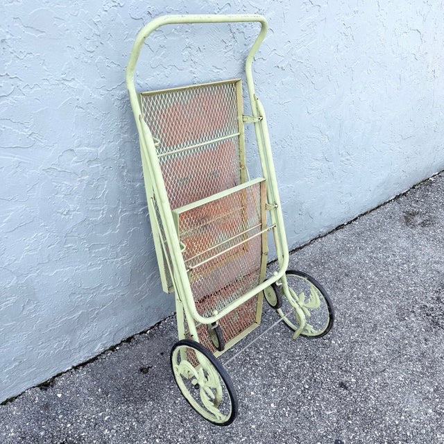 This vintage mid century rolling bar cart blends garden-party charm with clever practicality. Finished in a soft pistachio...