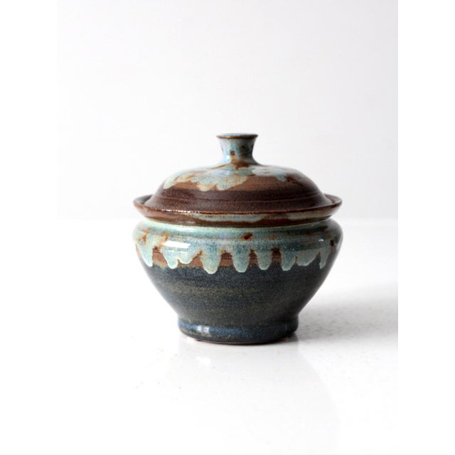 This vintage handcrafted ceramic piece is a versatile addition to any home. With its dynamic blue and brown glaze, it's a...