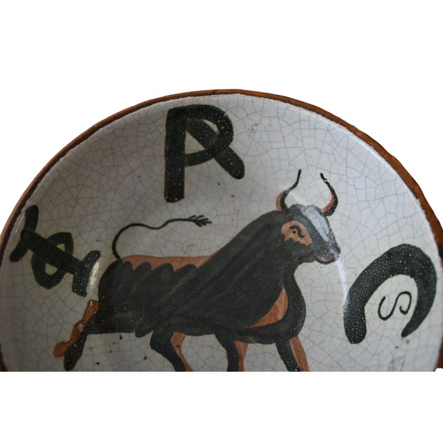 "Pablo Picasso -bull, Ceramic Bowl" A ceramic bowl covered with leather on the outside. The bowl is decorated with the...