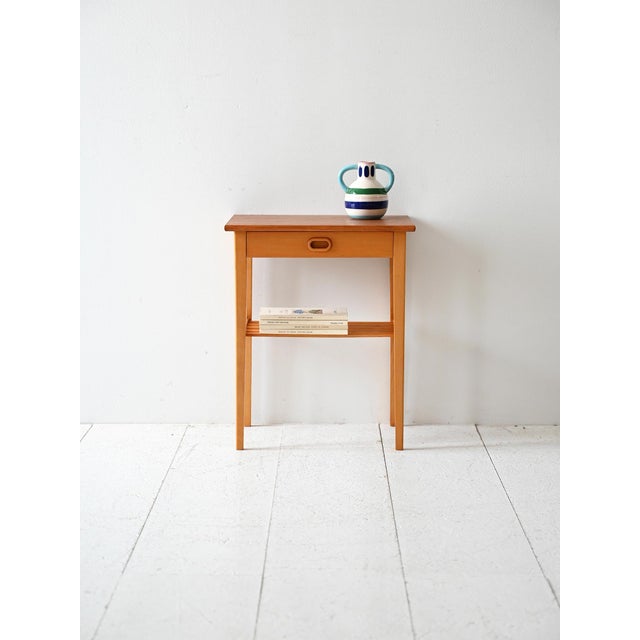 1960s oak bedside table, with built-in drawer and low slatted shelf. Original Scandinavian bedside table from the 1960s in...