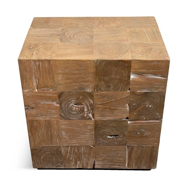 Crafted from squares of natural wire brushed teak laminated on a block base, this distinctive side table showcases the...