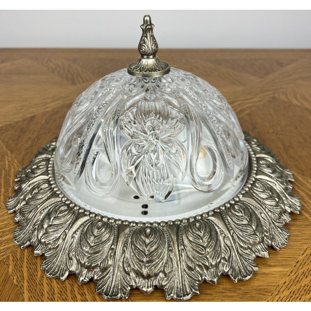 An elegant Vintage brass ceiling lamp featuring a beautifully detailed decorative glass shade with ornate floral and...