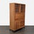Cherry wood and steel cabinet. Cabinet holds 50 bottles of wine, has 5 drawers, cabinet with shelf, and pull-out bar...