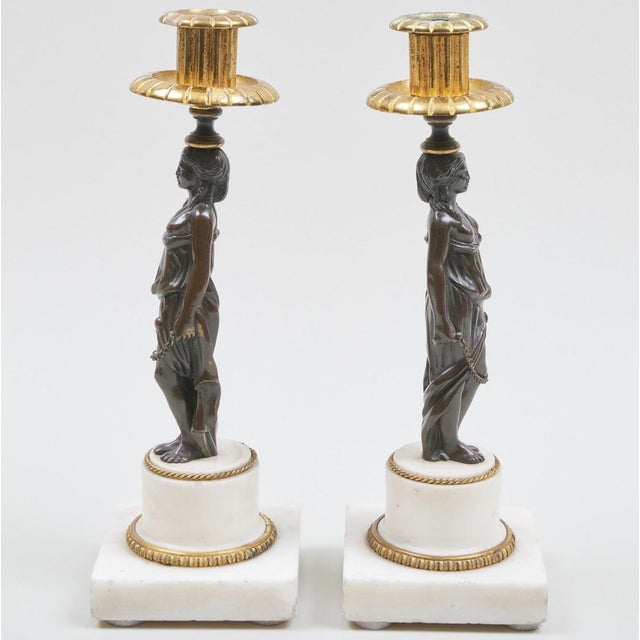Elevate your interior décor with this stunning pair of Napoleon III gilt and patinated-bronze caryatid candlesticks, a...