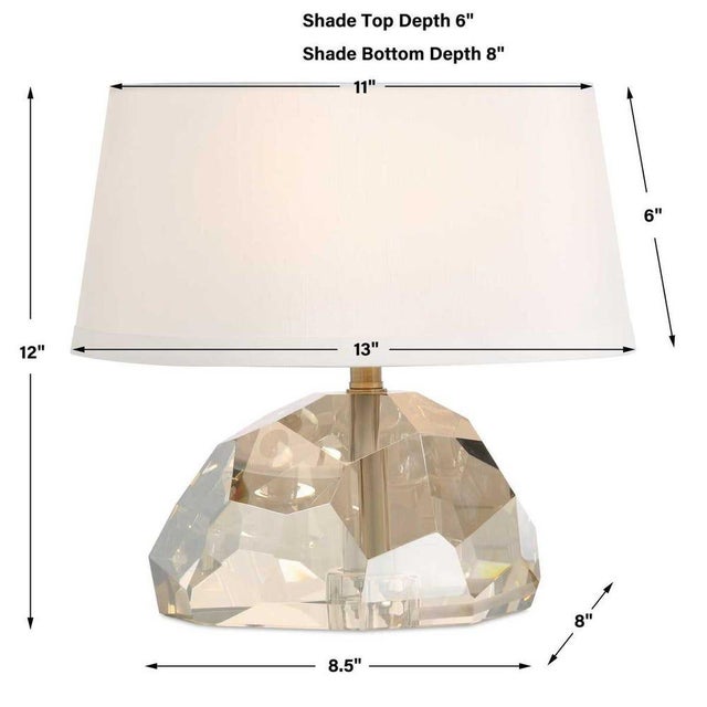 Champagne crystal with abstract facets refracts light for additional warmth and glow. Complete with beige fabric-wrapped...
