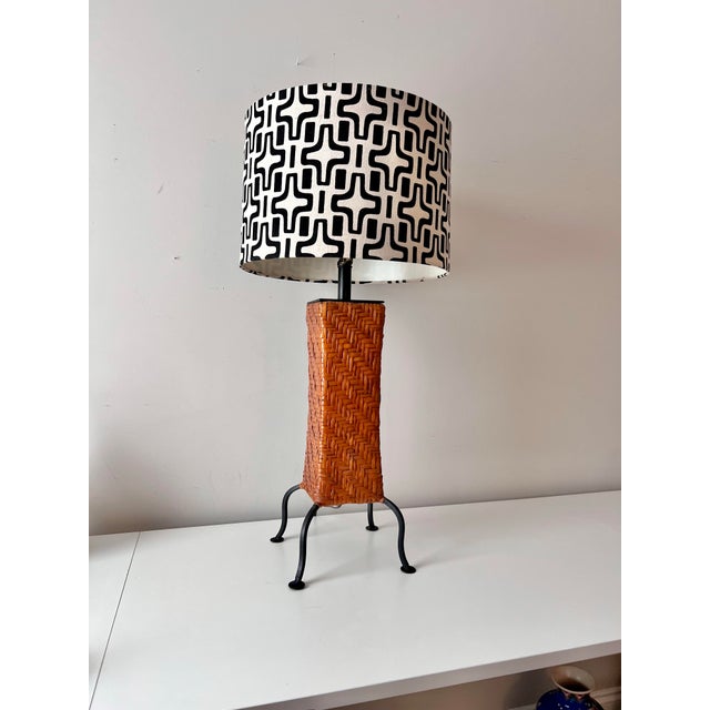 Unique vintage rattan and wrought iron table lamp in the style of Paul Mayen. The piece comes with original matching...
