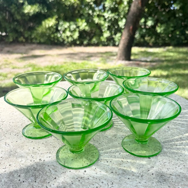A striking set of vintage Federal Glass sherbet dishes in a vibrant green hue, showcasing a classic mid-century pressed...