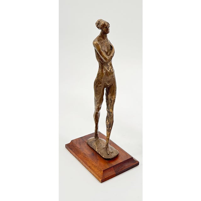 Courage is a powerful and expressive bronze figurine that captures a moment of quiet strength and self-assurance. With her...