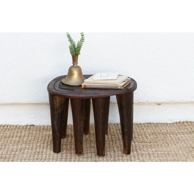 A unique piece of African art, this vintage Nupe table from Nigeria is a must-have for collectors and enthusiasts of Nupe...
