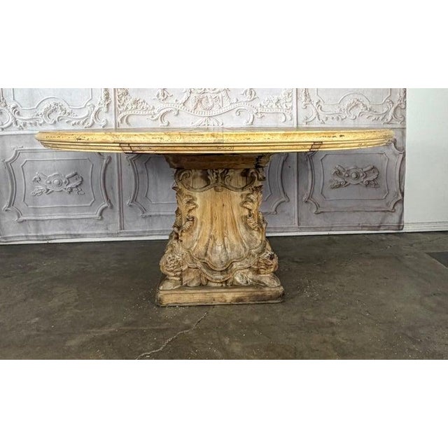An extraordinary and monumental French Baroque Revival round dining table, a true masterpiece of artisan carving and...