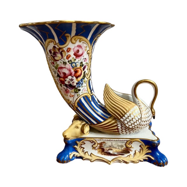 A fine a pair English of Early 19th century porcelain cornucopia vases. Each vase with swans and rams head elements and...