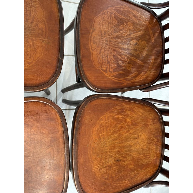 Set of four vintage Parisian bistro chairs from the 1960s. Chairs made of bentwood, with curved, spindle-backed seats and...