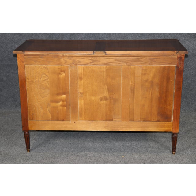 This handsome solid cherry French Directoire or Louis XVI style commode, crafted in the mid-20th century, carries the...
