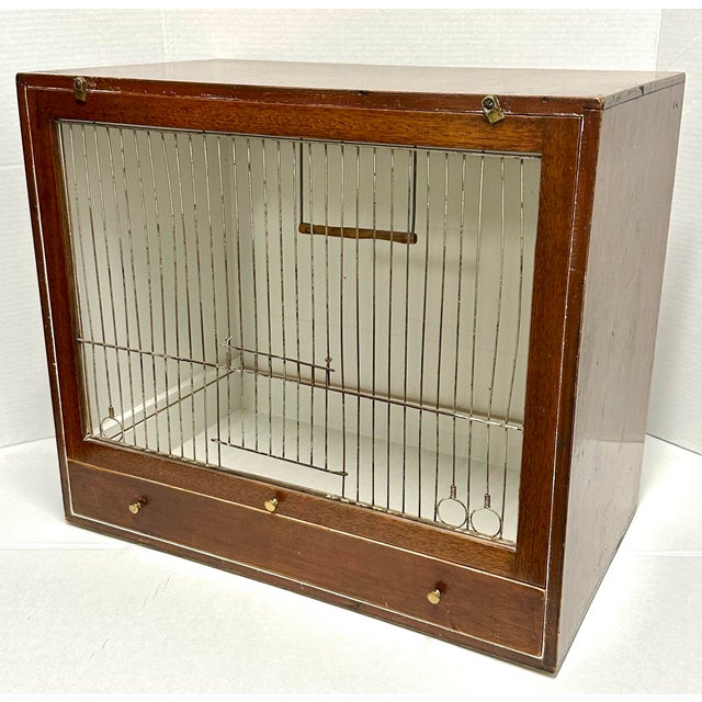 Fantastic walnut wood Edwardian birdcage with pullout tray, original wire front, and perch. Interior is painted ivory....
