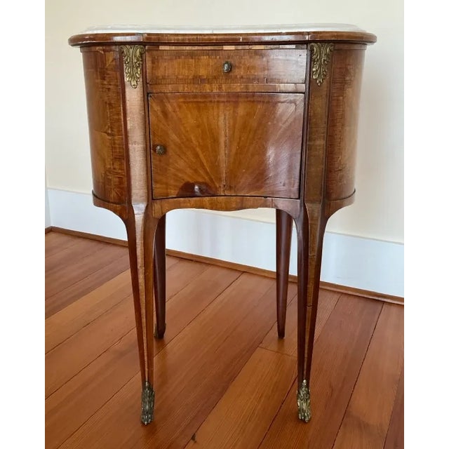 This charming antique French Louis XVI-style kidney-shaped (demi-lune) side/console table features elegant neoclassical...