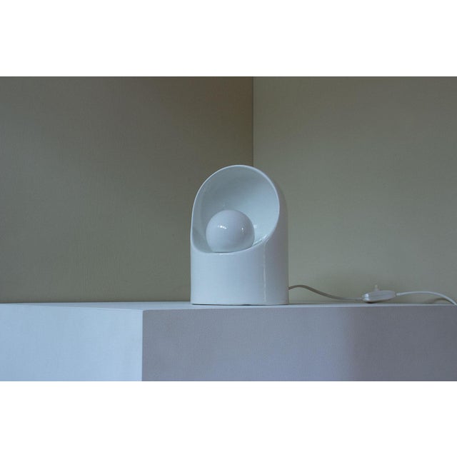 White ceramic table lamp, design attributed to Italian designer Marcello Cuneo. The lamp is very similar to a lamp...