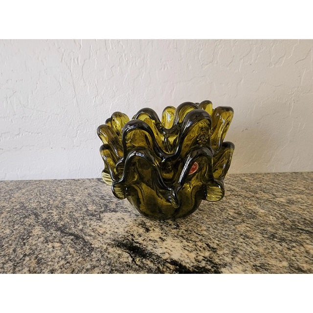 A set of three 1960s Italian art glass bowls in a rich olive green, each hand-tooled with pulled petal forms that ripple...