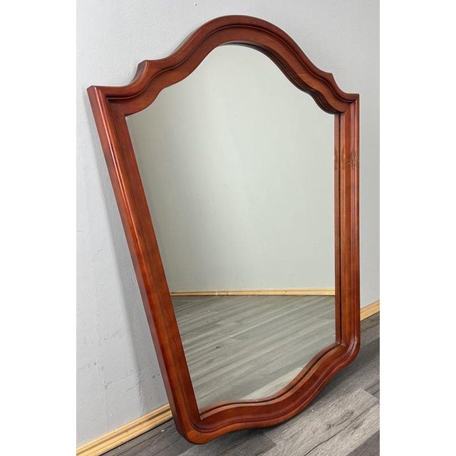 A charming vintage French mirror offering elegant curves and a classic silhouette. Its decorative shaped frame brings warm...