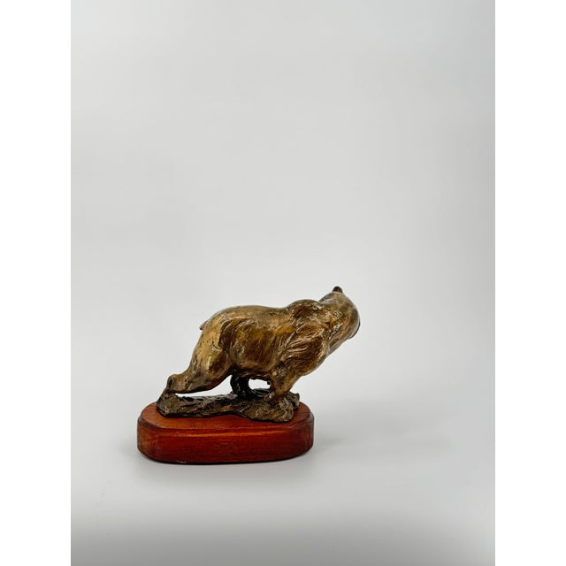 A powerful and expressive bronze sculpture capturing a bear mid-growl, frozen in a moment of raw intensity and natural...