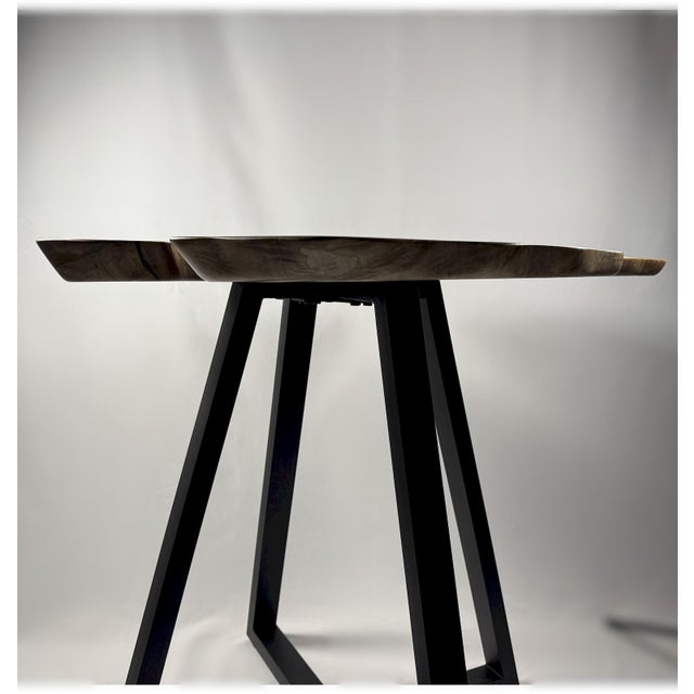 This piece features a dramatically tilted live-edge top carved from a highly figured slab of spalted maple, full of visual...