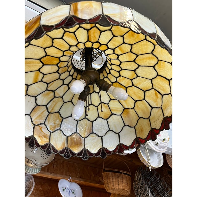 Large Slag Glass hanging Light. Cream Caramel Amber tones with Red Glass Edges. Measures 24” in diameter and is about 15”...