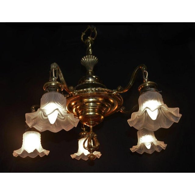 An impressive french five-light chandelier dating to the early 20th century, combining substantial brass and bronze...