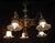 An impressive french five-light chandelier dating to the early 20th century, combining substantial brass and bronze...
