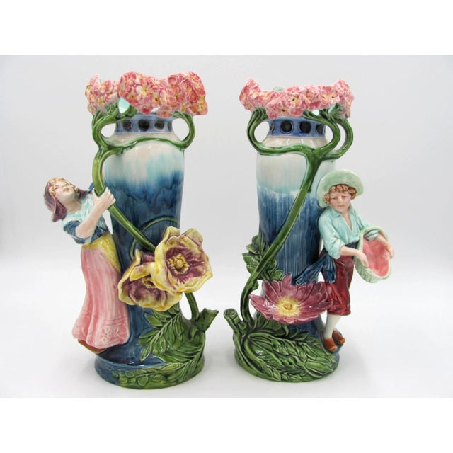 Circa 1900, multi-colored glaze of children in a forest, with impressed 'TC' mark on the sides at the base, and model...