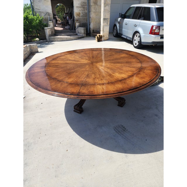 Beautiful stunning walnut 18th century style Therian Volute round dining table with extension leaves. The table is 63"...