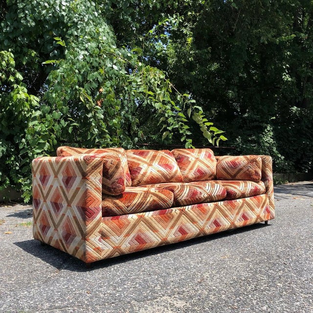 the raddest 1970s sofa! this set wears a plush geometric patterned velvet with warm tones and sits on short wooden peg...