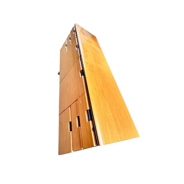 Solid wood with black metal frame and metal drawers on the inside. Excellent vintage condition. A mid century modern...