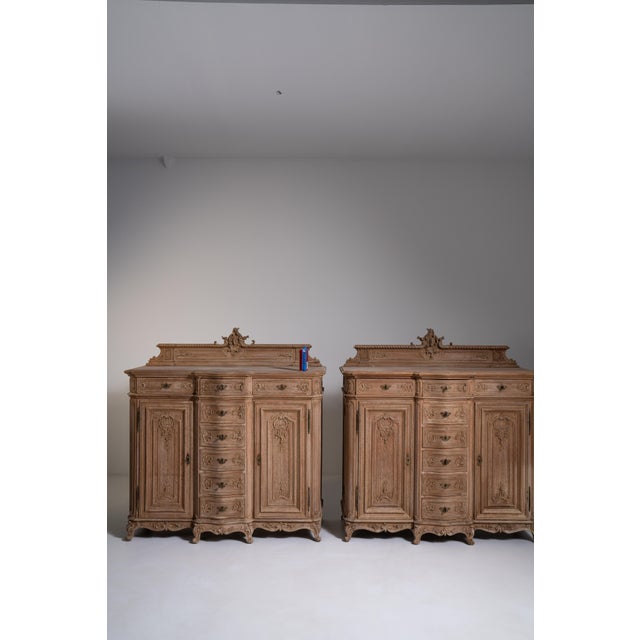 A high-quality pair of Louis XV style oak buffets featuring elegant curves and refined detailing. The matching set offers...