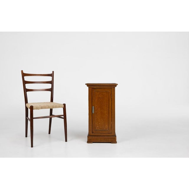 A French wooden nightstand from the 1930s that blends the clean geometry of Art Deco with the warm, tactile charm of...
