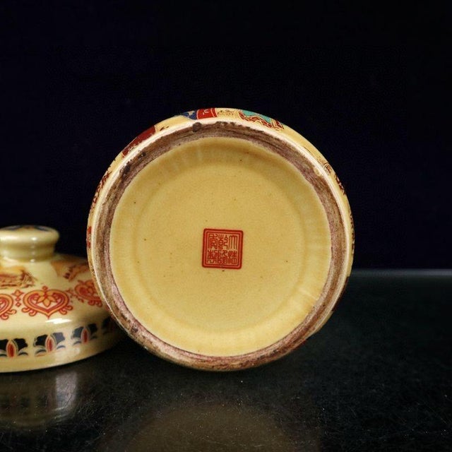 Lovely lidded porcelain jar decorated with a traditional scene of Japanese geisha ladies in ornate kimono robes against...