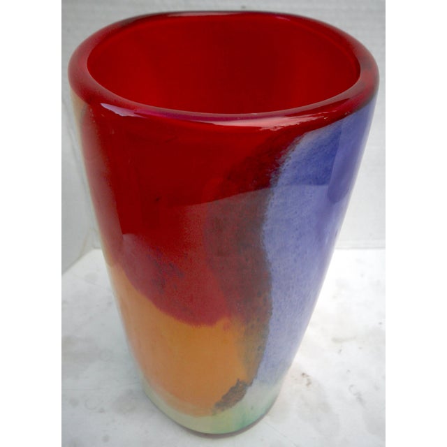 This hand-blown art glass vase, measuring 12 inches tall by 6 inches in diameter, is a heavy-duty centerpiece offering an...