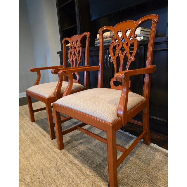 Pair of Chippendale style chairs in a beautiful lacquered finish the color of paprika and upholstered in a neutral woven...