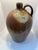 A monumental antique salt-glazed stoneware jug or flagon dating to the 19th century. This substantial hand-thrown vessel...