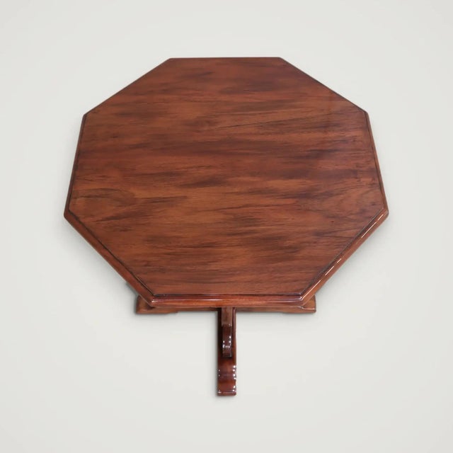 The Gothic Revival Mahogany Accent Table is built in solid mahogany: an octagonal top with a dentil-carved frieze, set on...