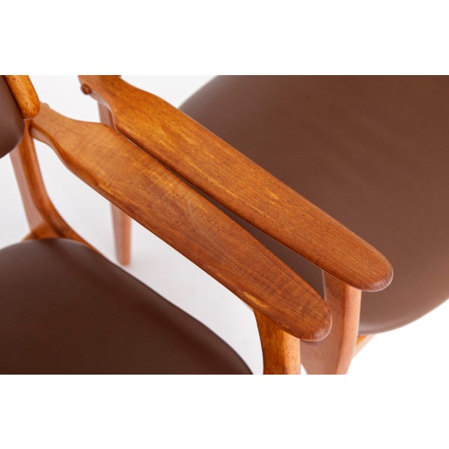 2 armchairs by Danish designer Erik Buch, model 49, produced in Denmark during the 1960s. The solid teak wood frames have...