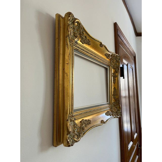 Beautiful vintage carved gilt wood frame. Large and heavy, this piece measures 18 x 24.75 x 2.5 overall. Interior opening...