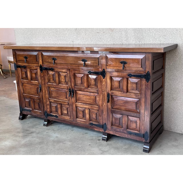 From Northern Spain, constructed of solid oak, the rectangular top with molded edge atop a conforming case housing three...