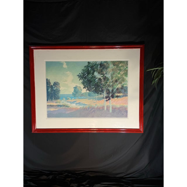 Oversized framed landscape artwork featuring a soft coastal / countryside scene with blue, green, pastel, and neutral...
