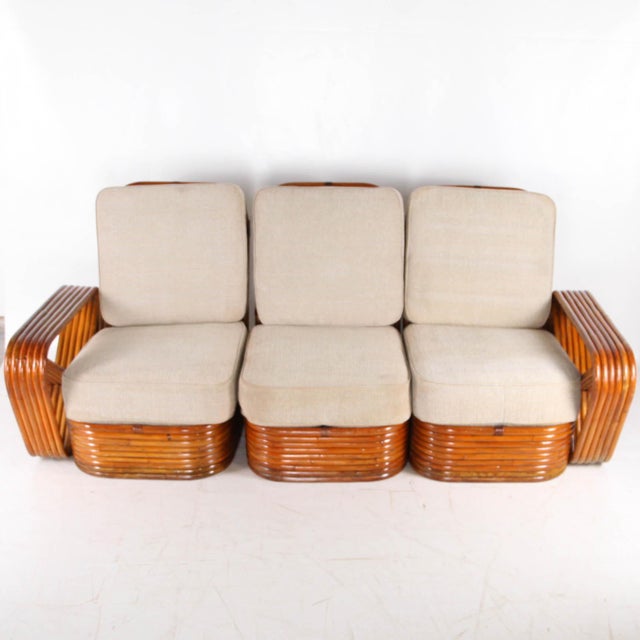 Rare rattan sofa by Paul Frankl from the 1970s. Comprising three modules upholstered in a beautiful heathered fabric, this...