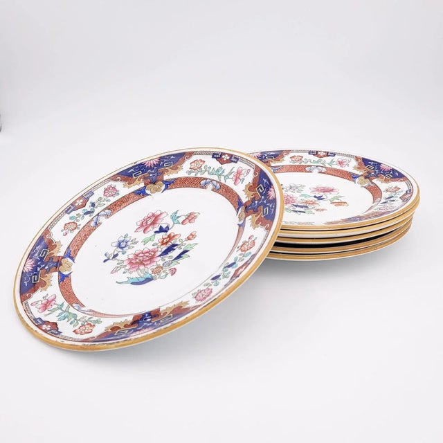 A set of six Imari style plates, England circa 1870. The center of the plates is decorated with with flowers. The rim is...