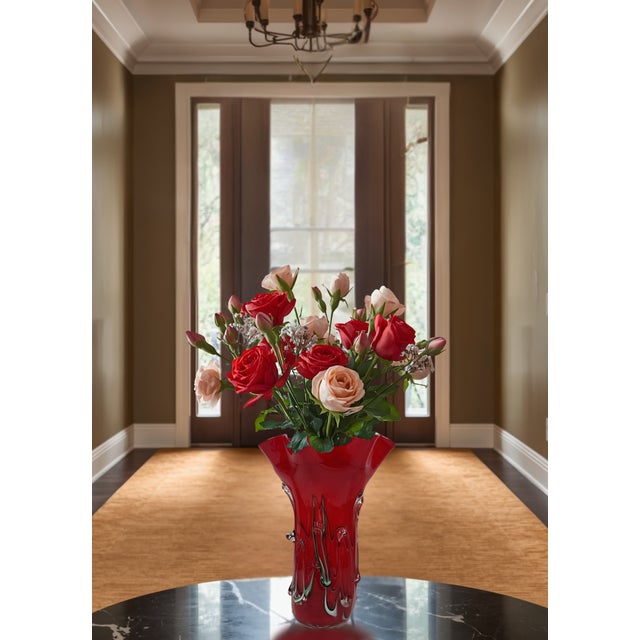 This vintage Murano vase stands 12 inches tall and 9 inches wide, with a full cylindrical body that rises into a wide,...