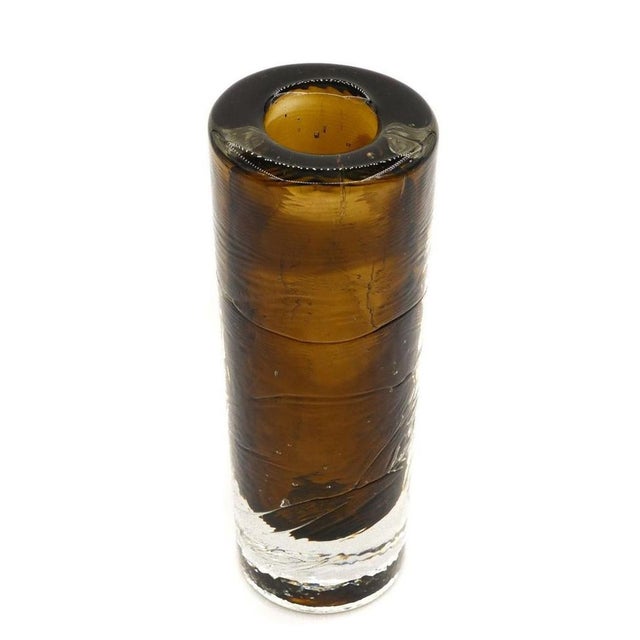 This vintage brown glass vase is a decorative object manufactured in Northern Europe circa 1970s. Thick vase in brown...