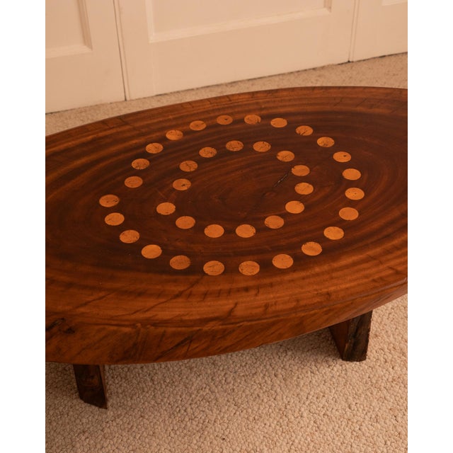French - 1960s Brutalist coffee table made from a mahogany trunk inlaid with circular decorations in light wood. Two...